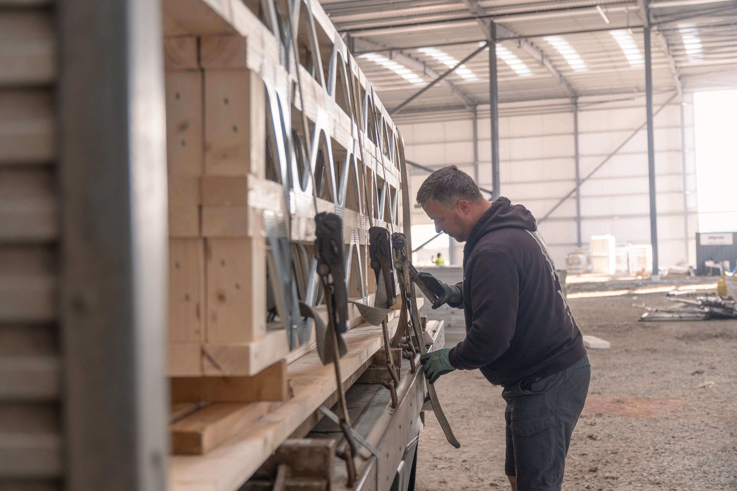 man unloading posi-joists from a lorry in Worcestershire