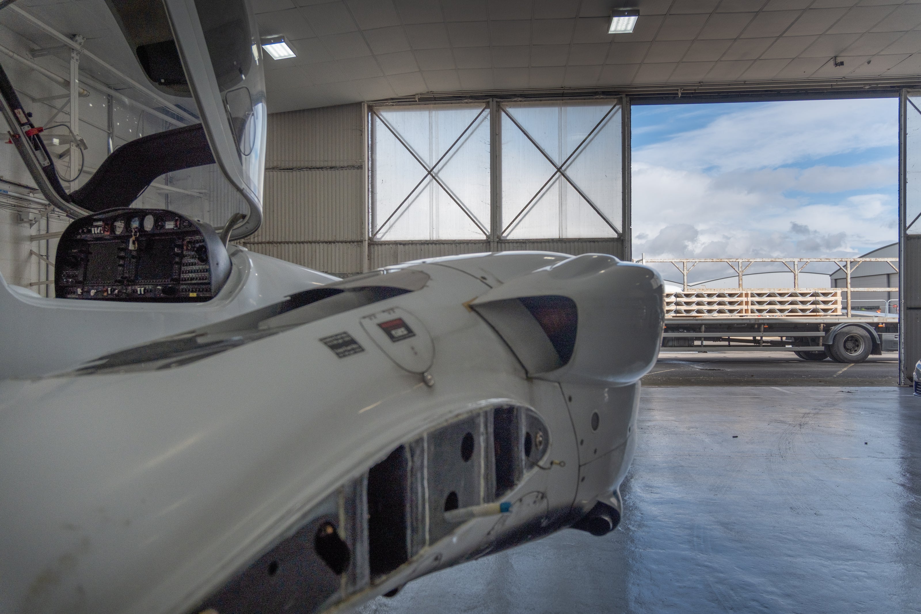 aircraft inside hangar with lorry delivering posi-joists outside