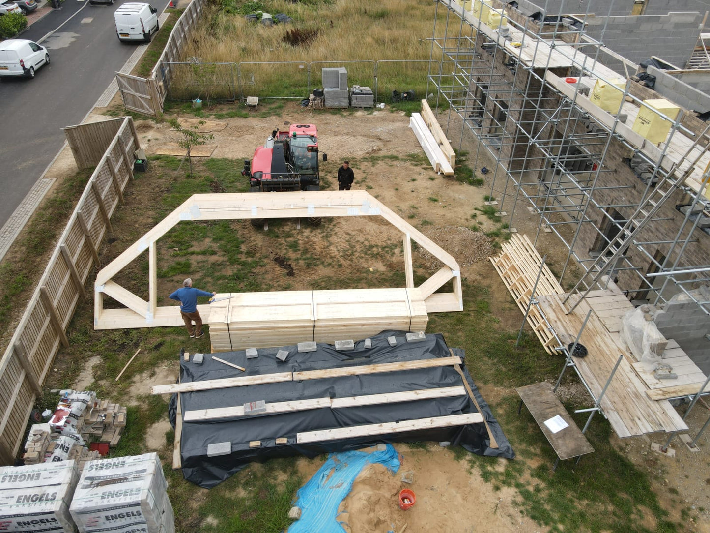 birds eye view of attic trusses being lowered onto a building