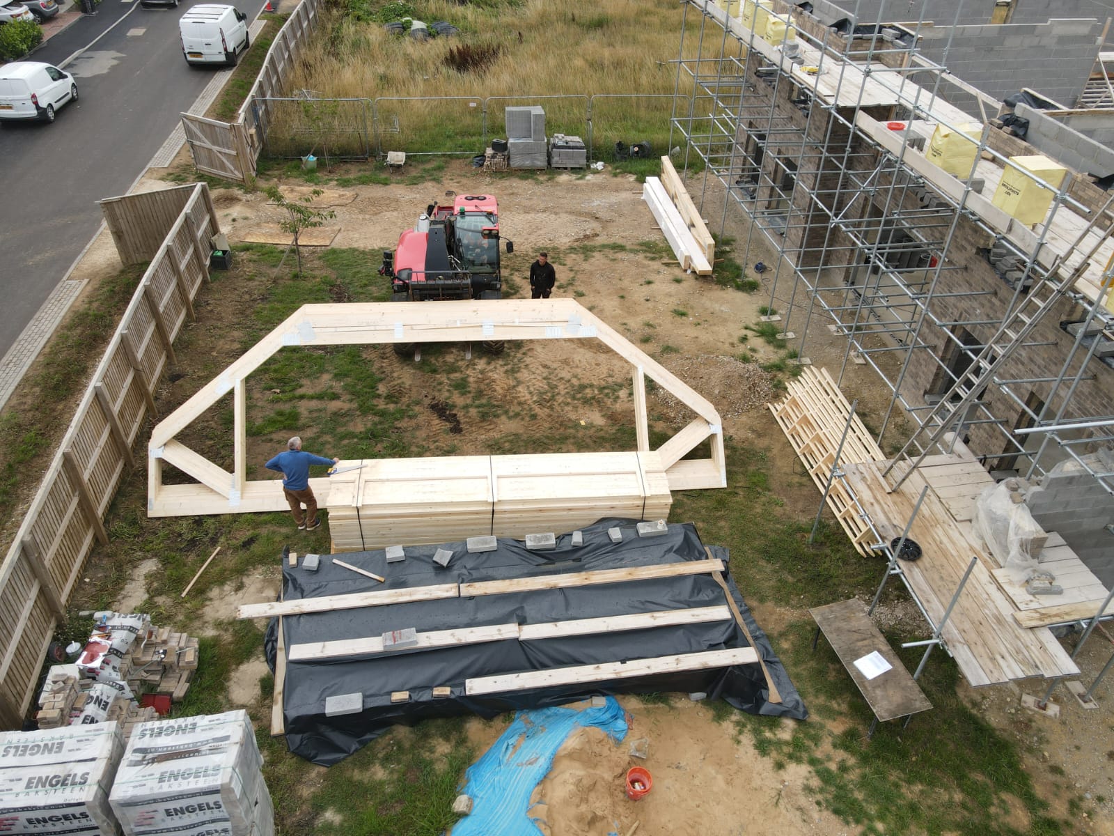 birds eye view of attic trusses being lowered onto a building