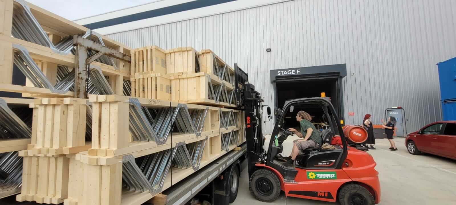 posi-joists being unloaded from a lorry with a forklift