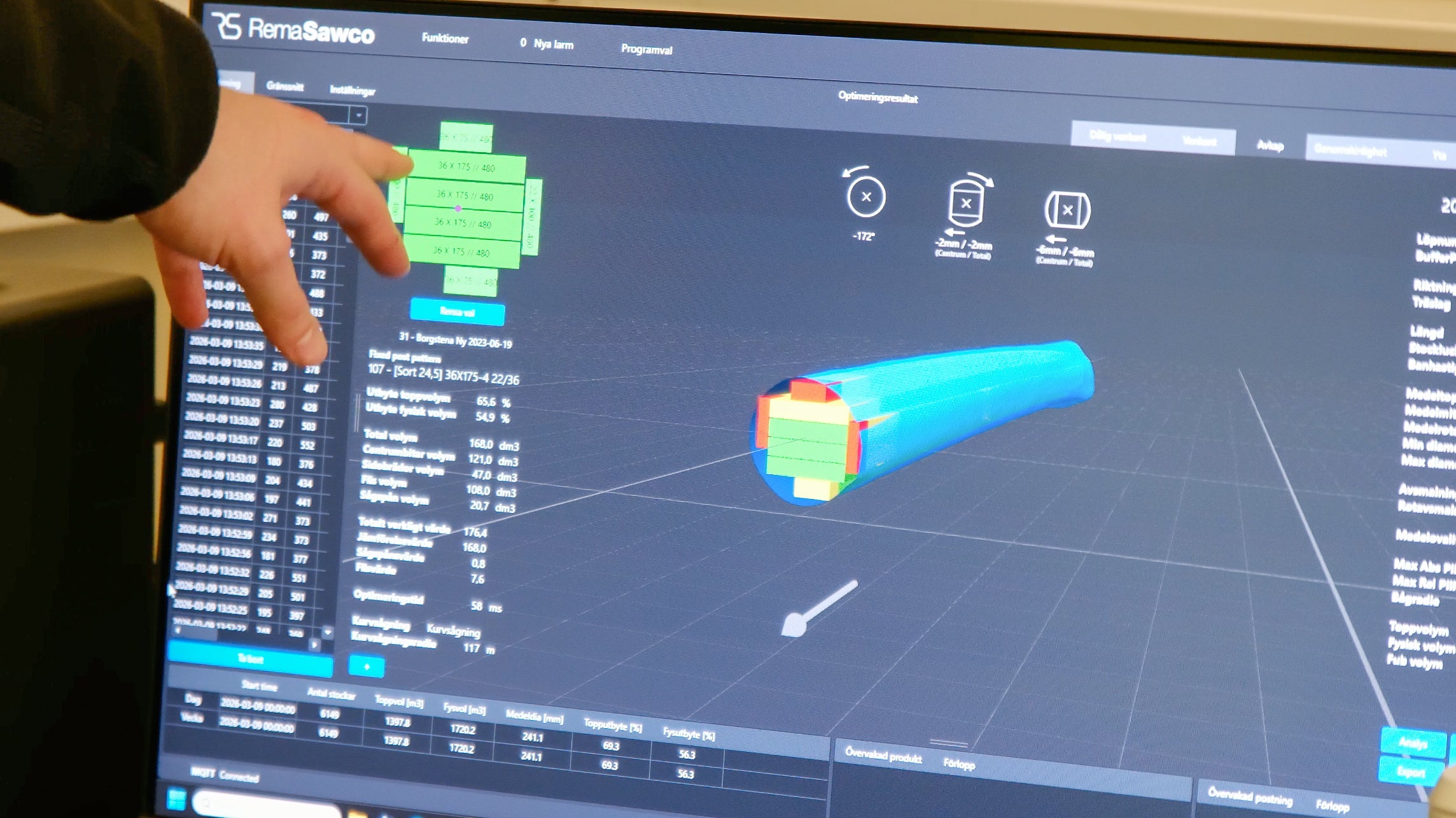 Person interacting with a computer screen displaying 3D modeling software.