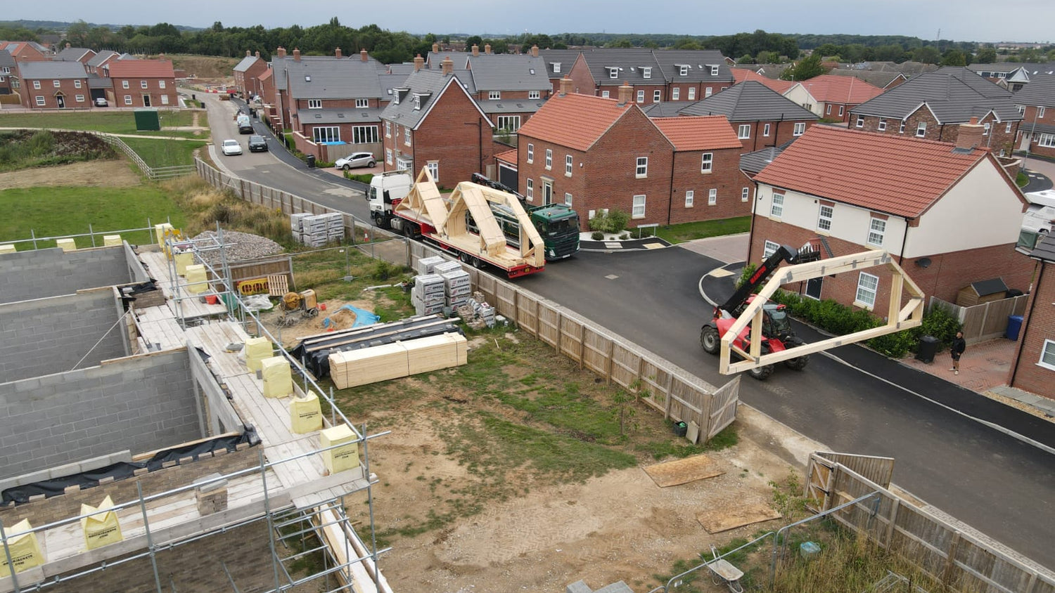 attic trusses being delivered to a new house