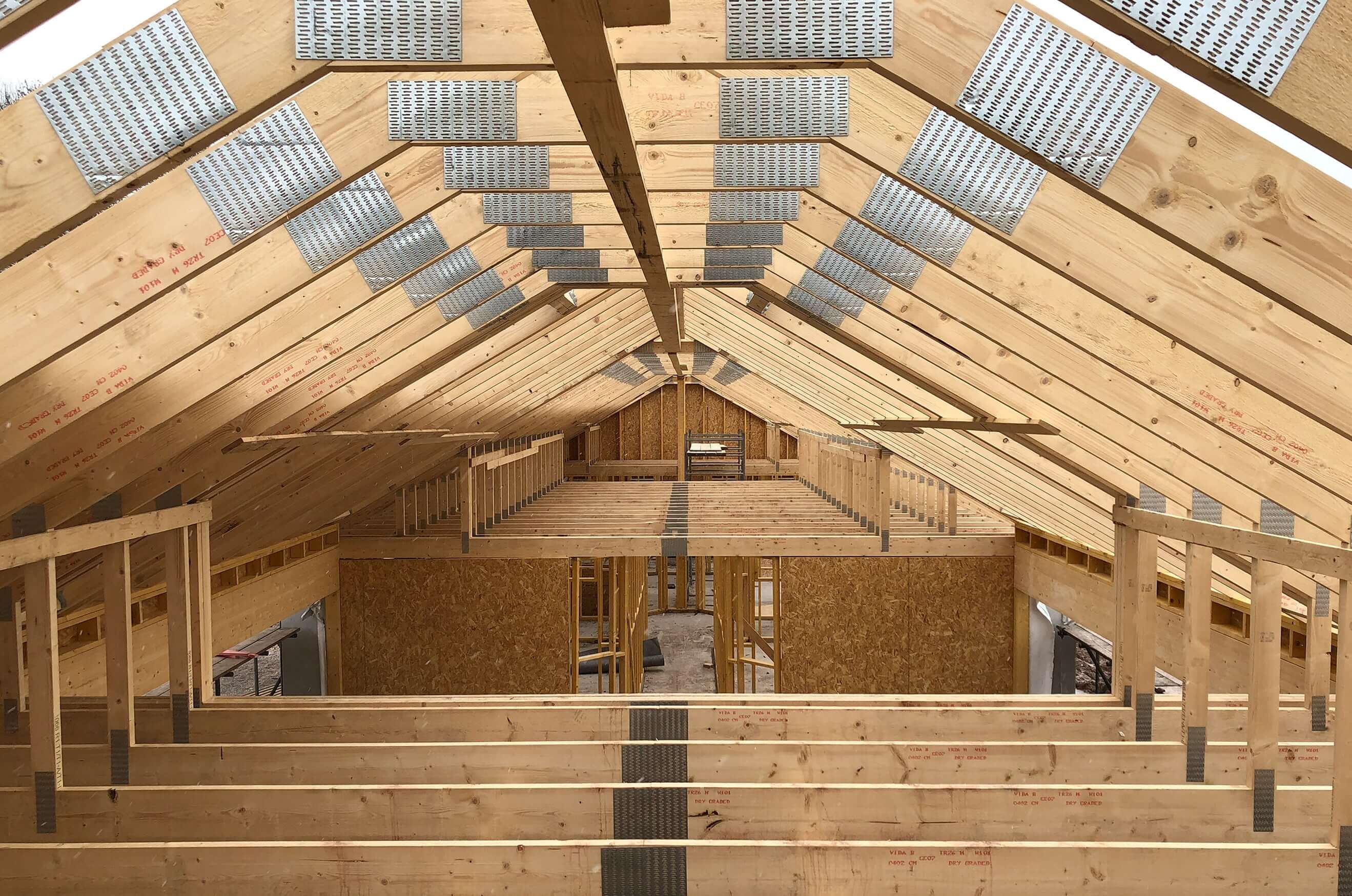 Attic trusses being installed on a home