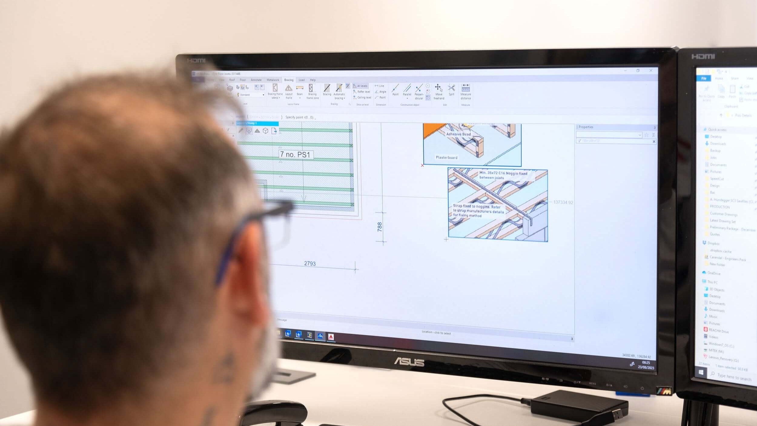 Designer sat at a computer in an office