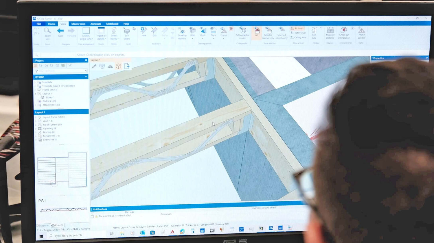 A Posi-Joist designer working on a computer
