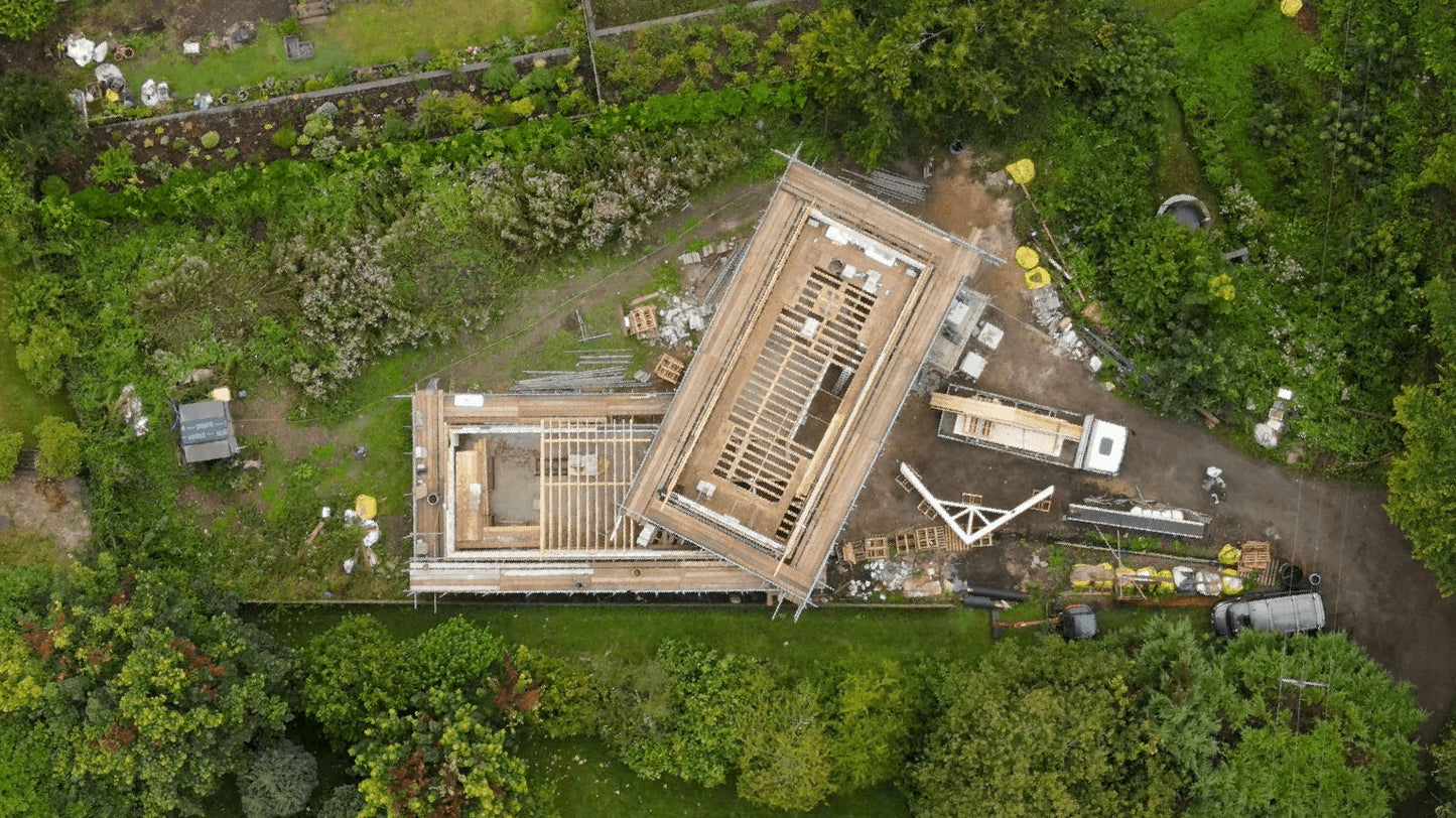 an aerial view of posi-joists installed on a building surrounded with trees