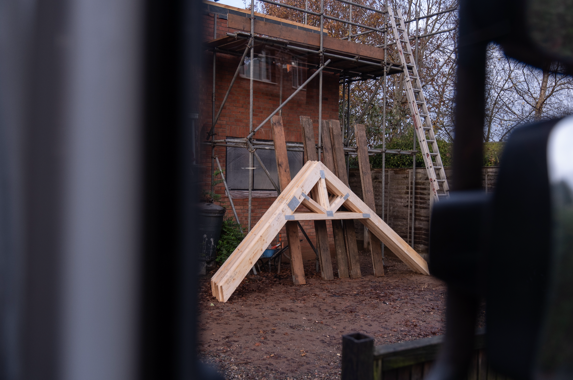 raised tie trusses leant up against a building