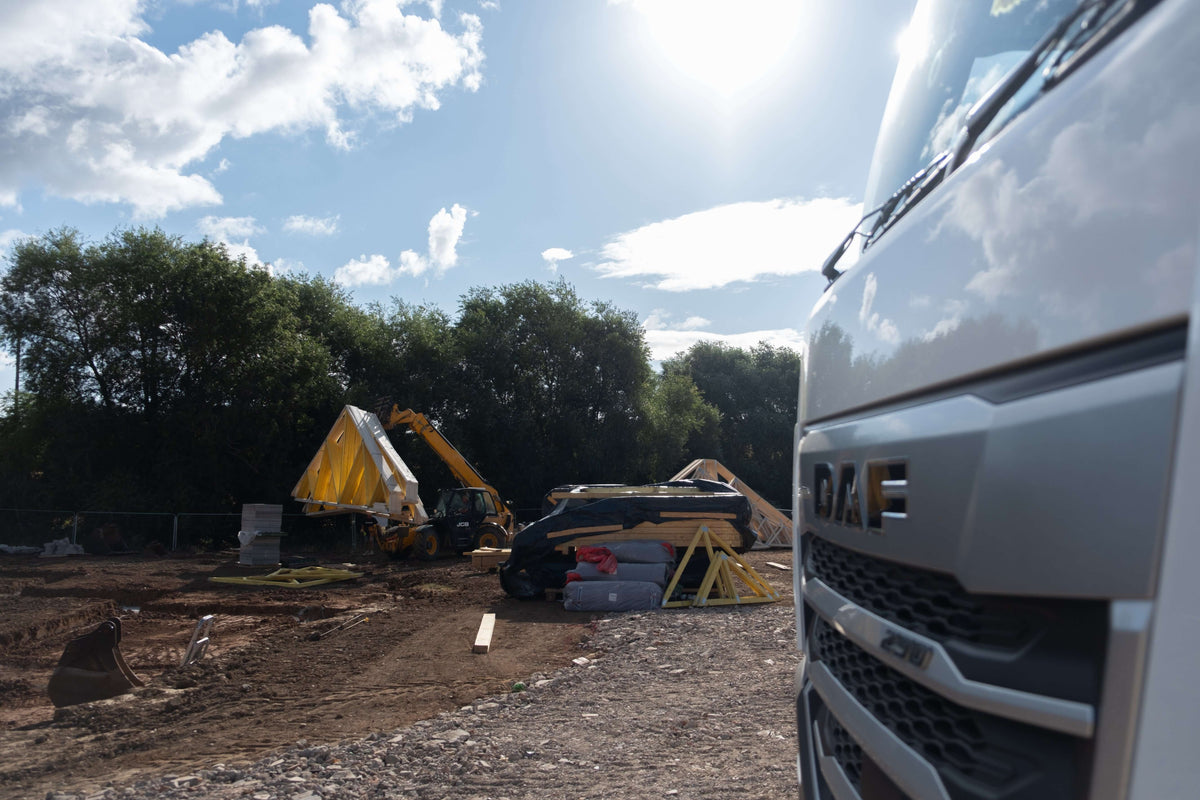 timber roof trusses being unloaded from a DAF lorry near Evesham