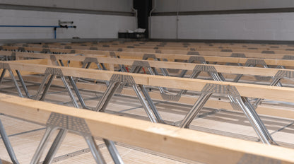 posi-joists installed in a floor with cabling running through the open webs