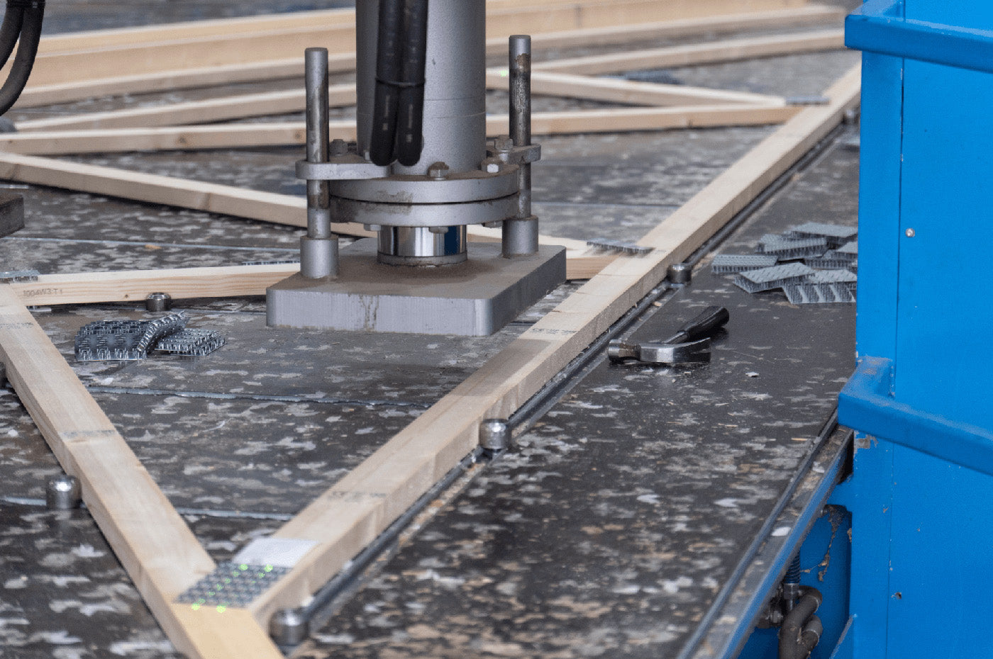 Close up of a truss press above a timber roof truss